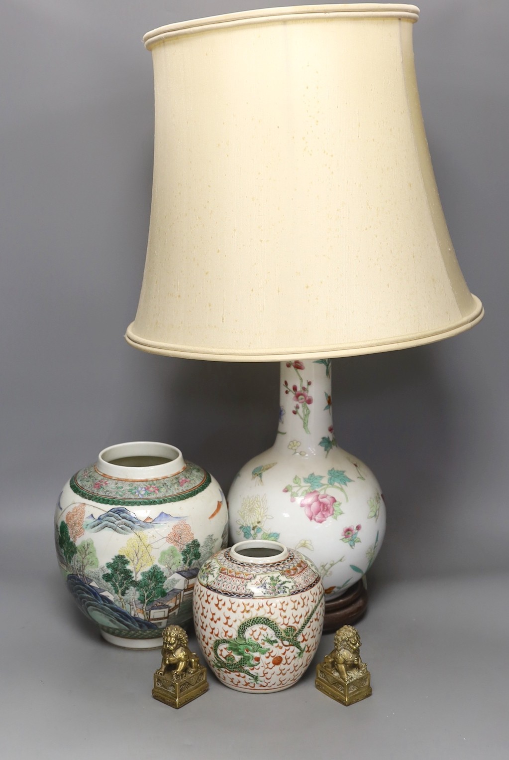 A Chinese table lamp, two Chinese Republic period enamelled porcelain jars, tallest 18.5 cm two brass lion dogs, lamp base 43 cm high (not including light fitting.)